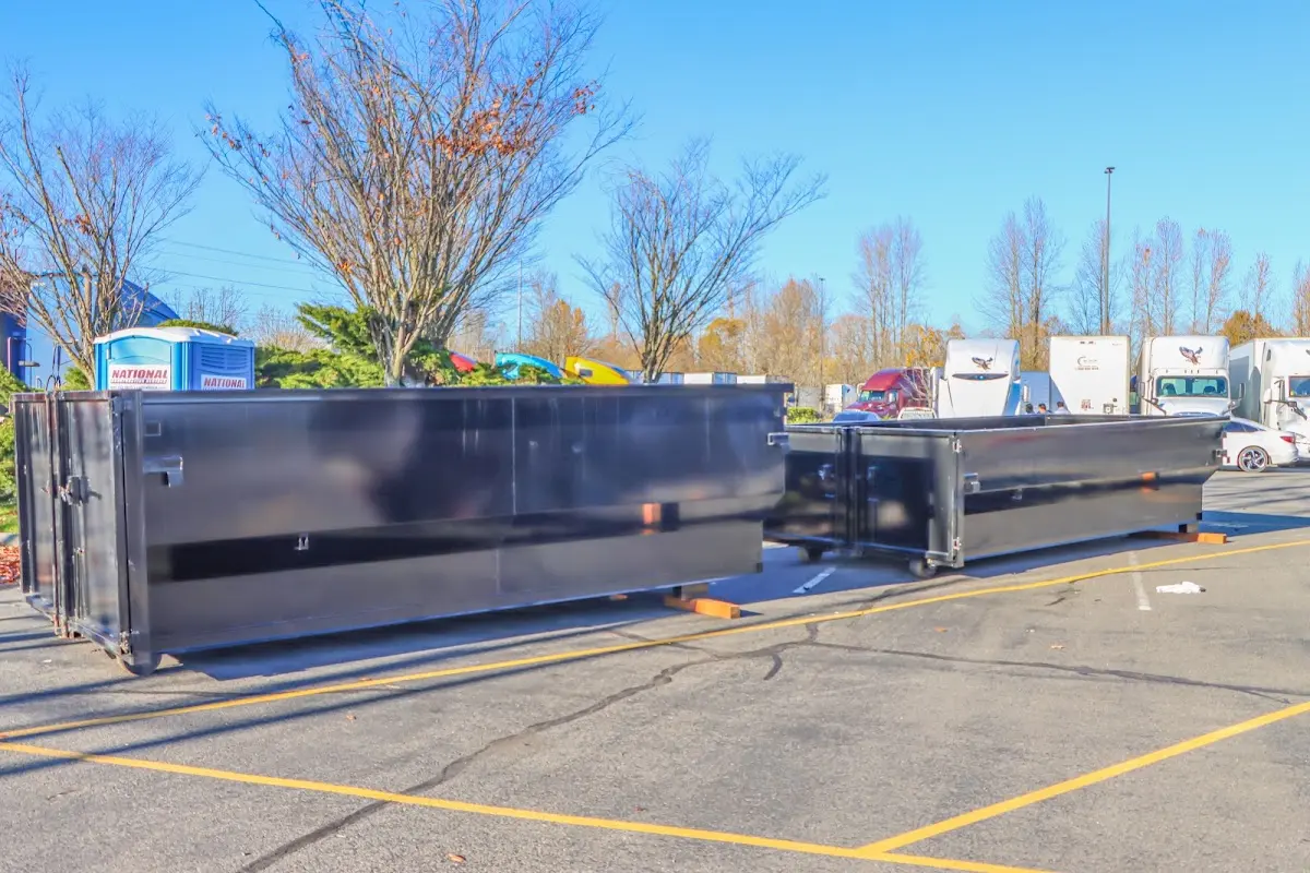 Professional dumpster rental service with roll-off container on residential driveway in Bainbridge